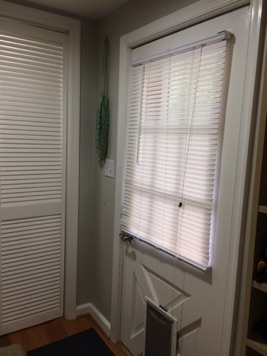 Once inside, there is a closet for coats and outdoor patio needs behind louvered doors